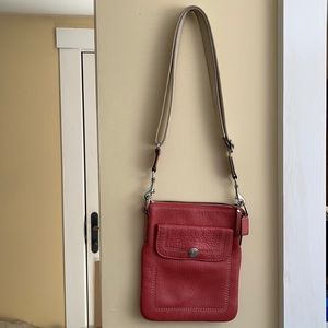 Coral colored Coach small cross body handbag